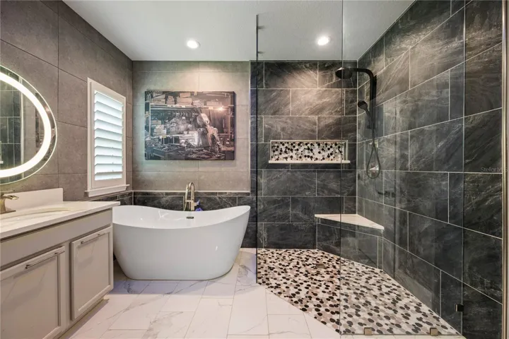 Private retreat with a custom designer accent wall and dual walk-in closets.