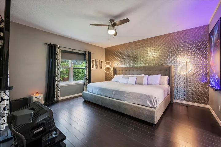 Spacious Primary Suite featuring custom designer accent wall.