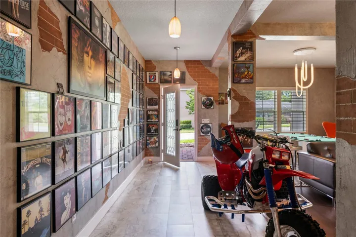 Welcoming foyer, formal living and dining spaces feature custom faux brick and textured wall finishes created by an artist who contributed to the Wizarding World attractions at Universal Orlando.