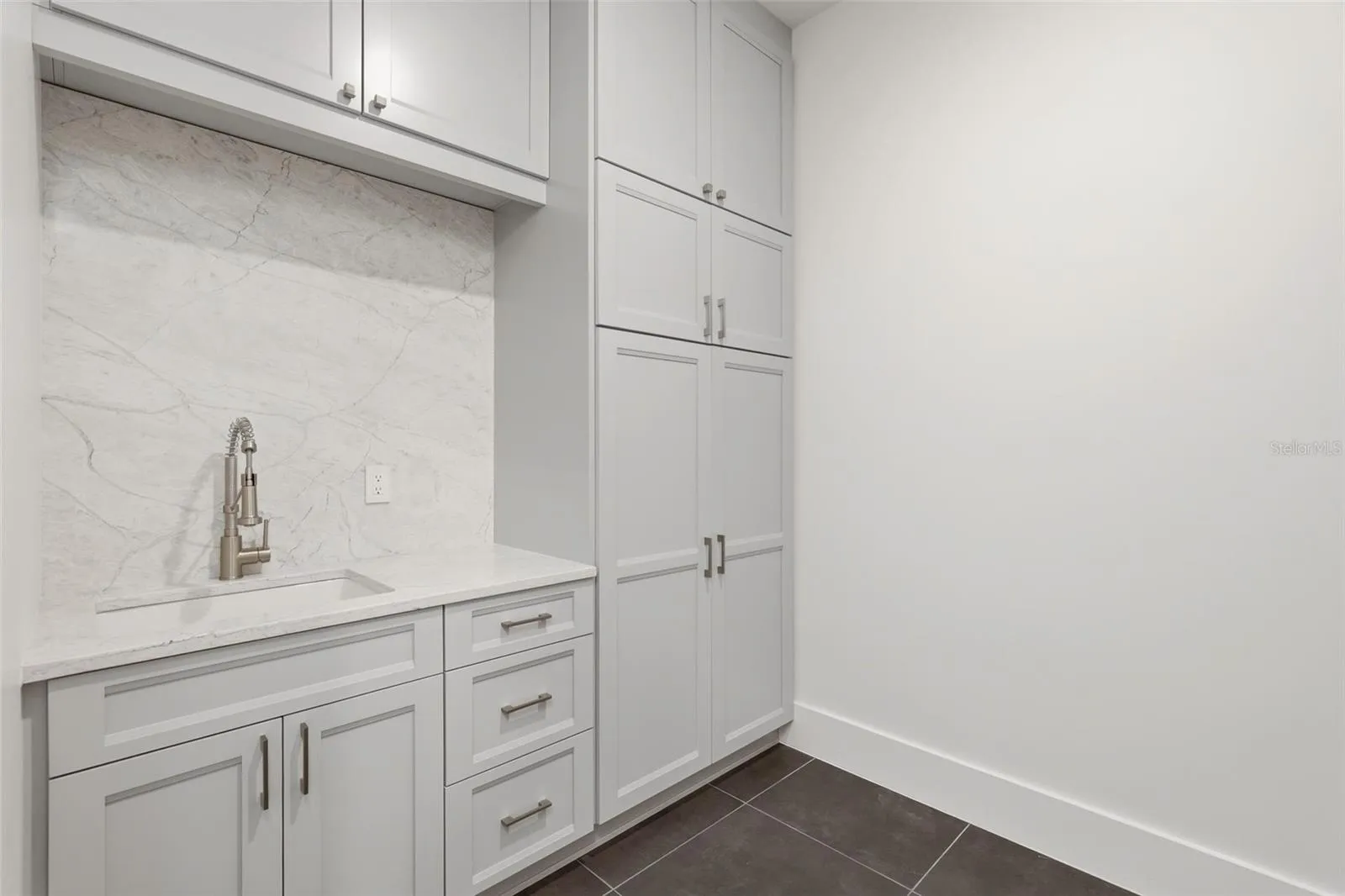 Upstairs laundry room with custom cabinets &amp; utility sink