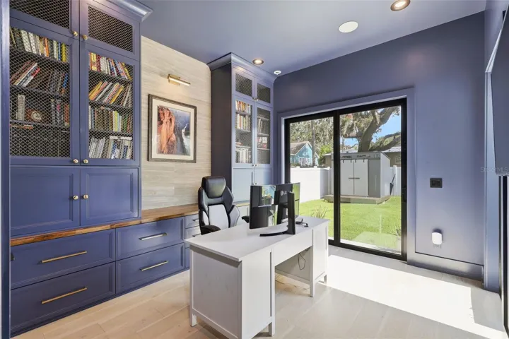 Office with custom cabinetry, and direct access outdoor areas