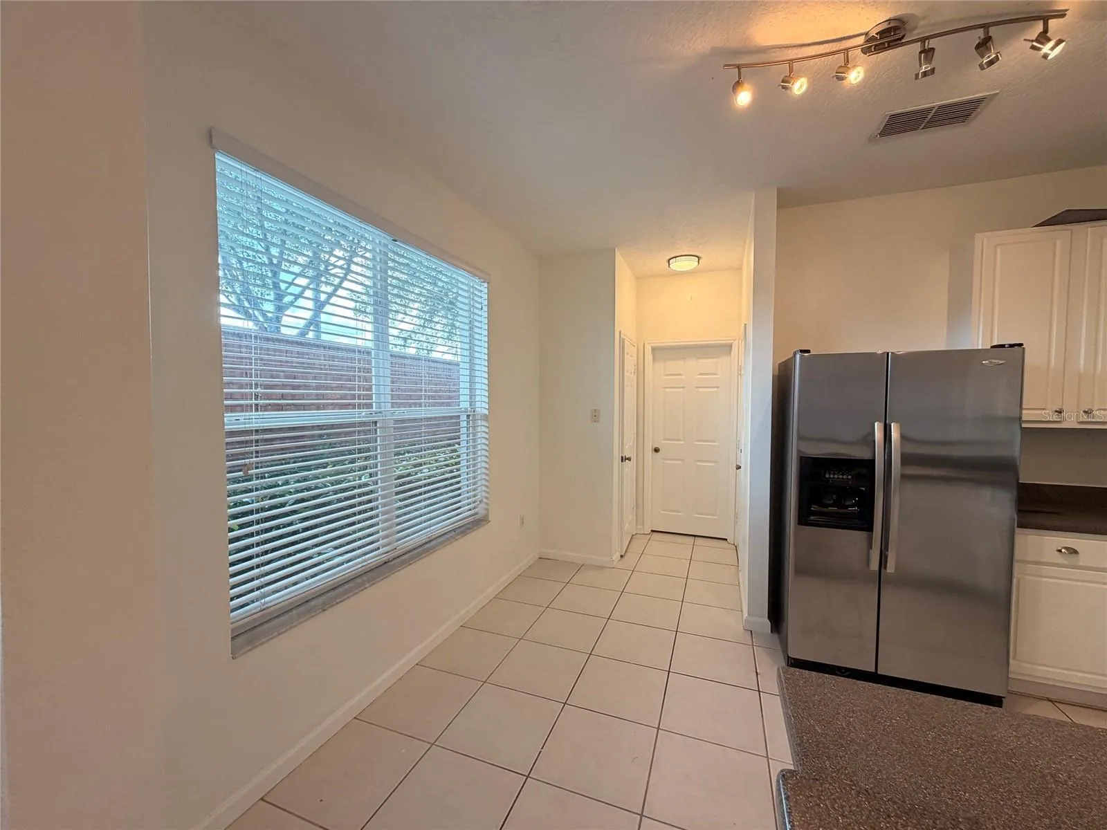 Kitchen hallway to half bath and Garage