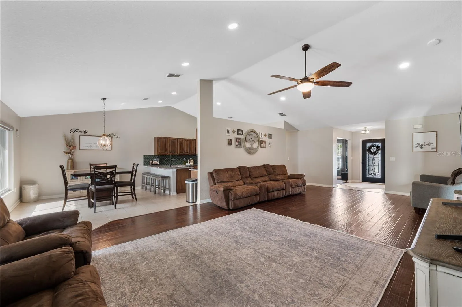 The main social space in the home, the GREAT room...features vaulted ceilings, wood flooring, new ceiling fans ,fresh paint in 2021 , recessed lighting and loads of space for family fun. This space flows seemlessly into the breakfast room and beautifully updated kitchen .