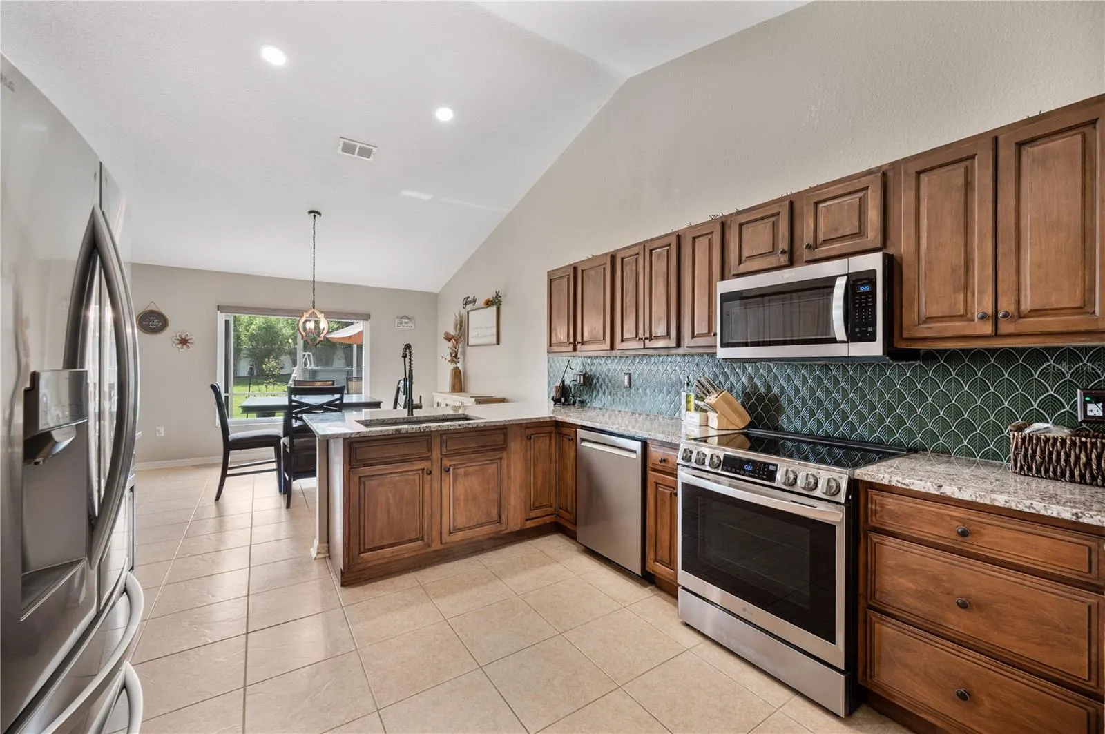 Into the freshly updated kitchen, stainless appliances , granite counter tops, designer tile back splash, huge breakfast bar and an eat-in space over looking a huge very private back yard.