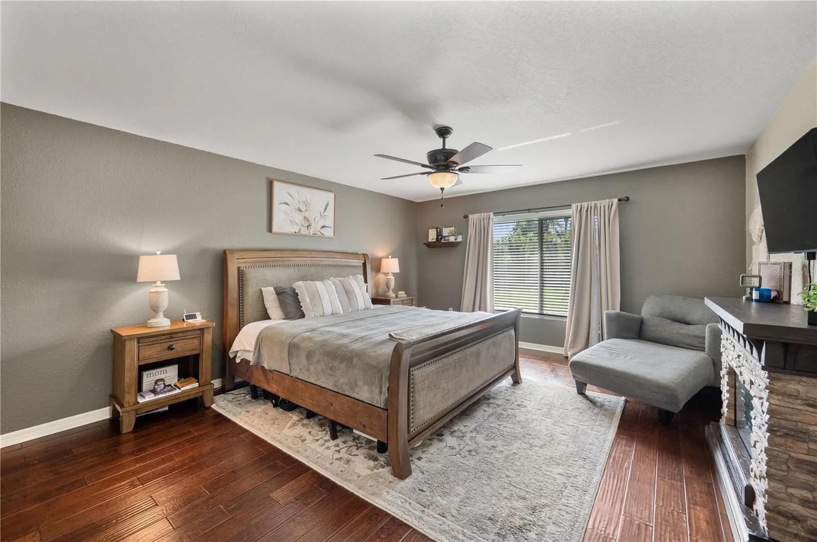 The Primary bedroom, featuring wood flooring, newer ceiling fan , fresh paint in 2021