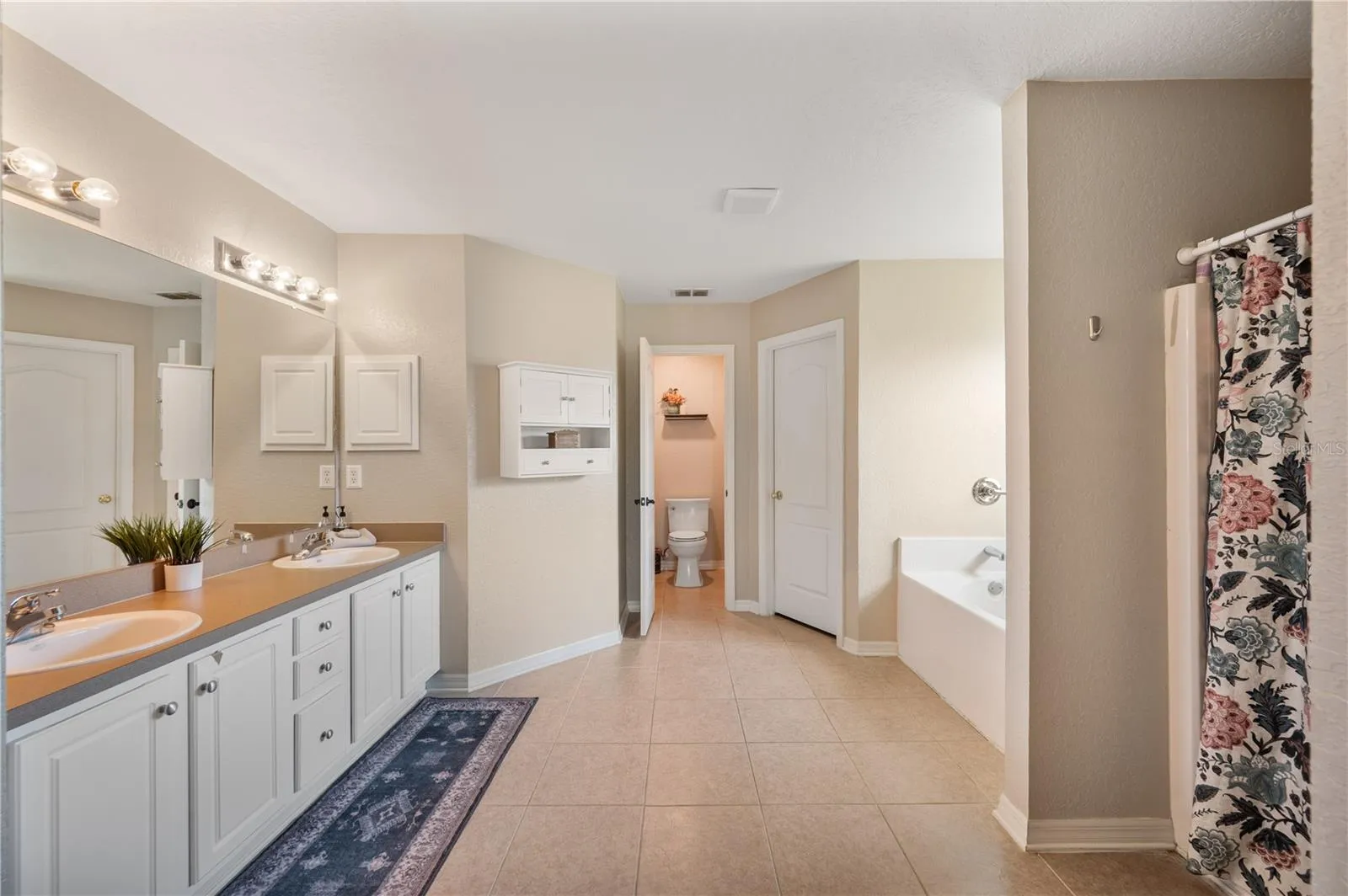 The Primary en-suite bathroom, boasts and separate shower, private commode,2 large HIS & HER walk in closets, double vanity ,garden tub and linen closet