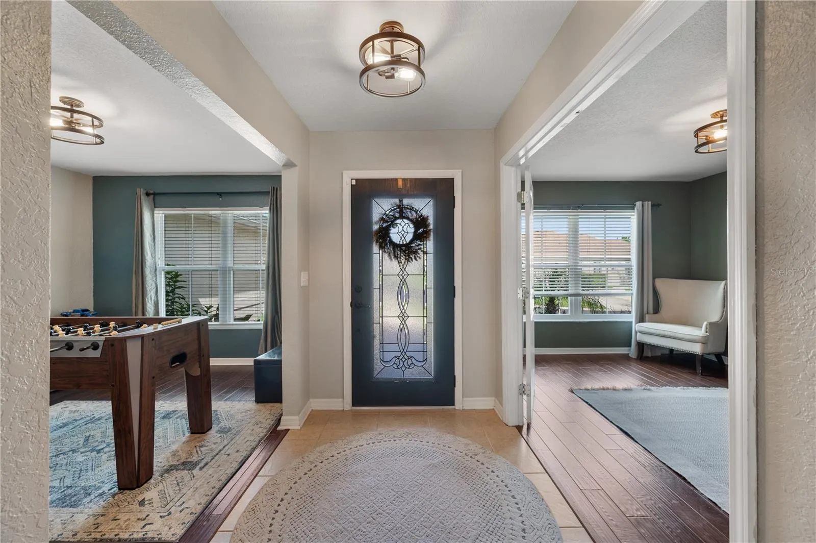 The main entry way is flanked by the dedicated spacious office and formal dining , both feature woodflooring and new light fixtures.