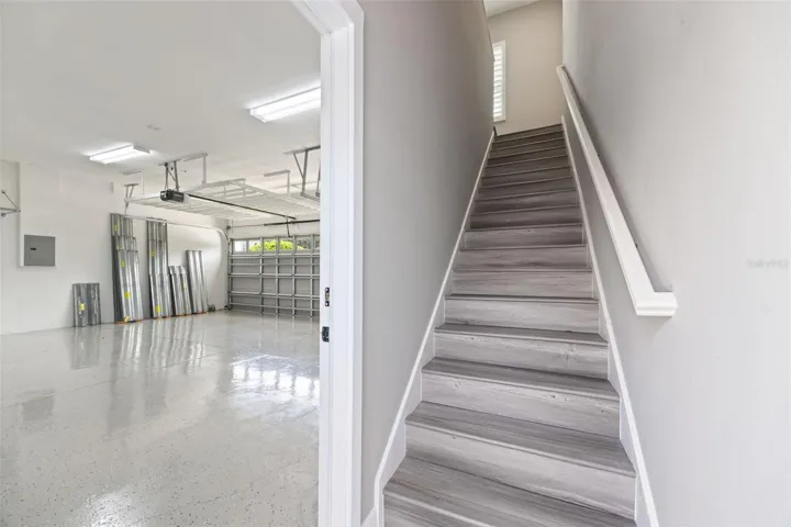 3-car Garage and stairs to Carriage House Apt