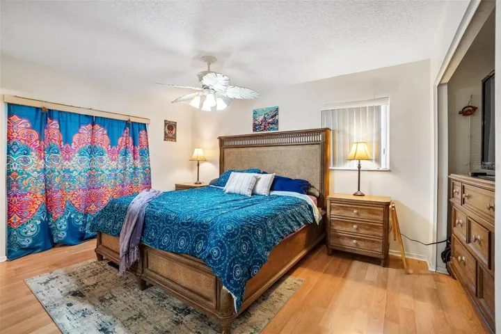 Primary bedroom w/ slider door behind curtains