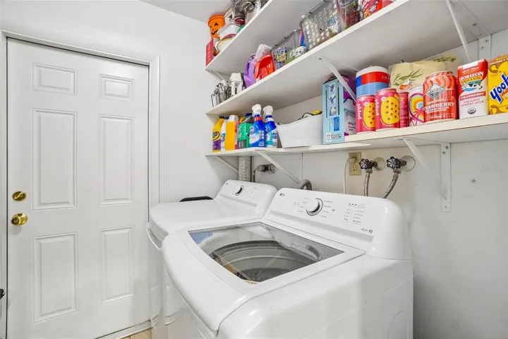 Laundry room with storage shelves