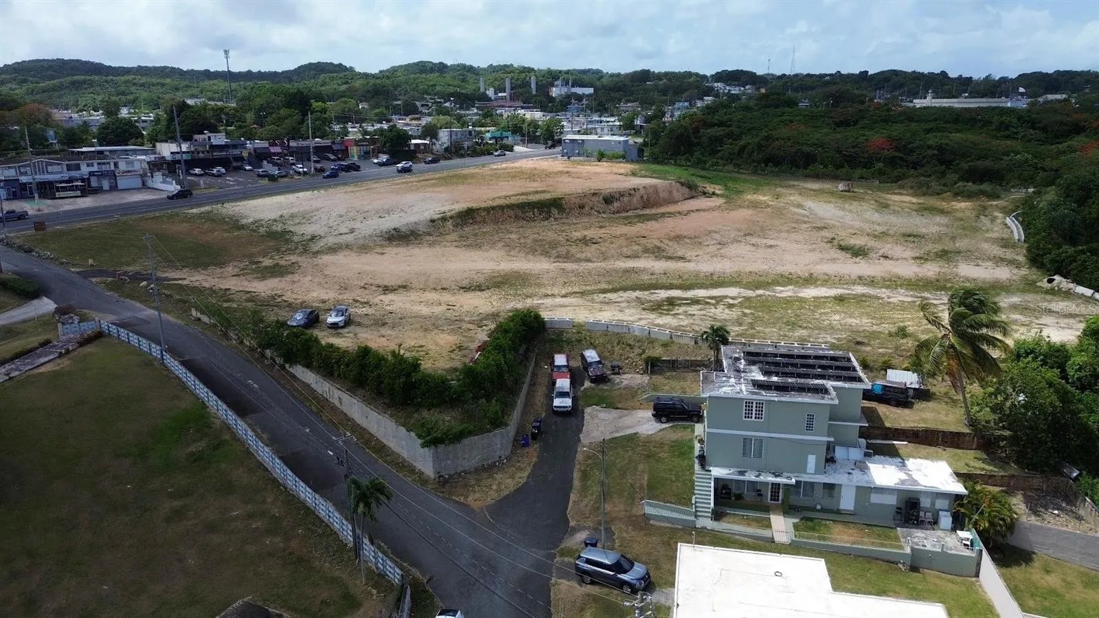 Aerial view showing the property's footprint, parking area, and surrounding neighborhood.