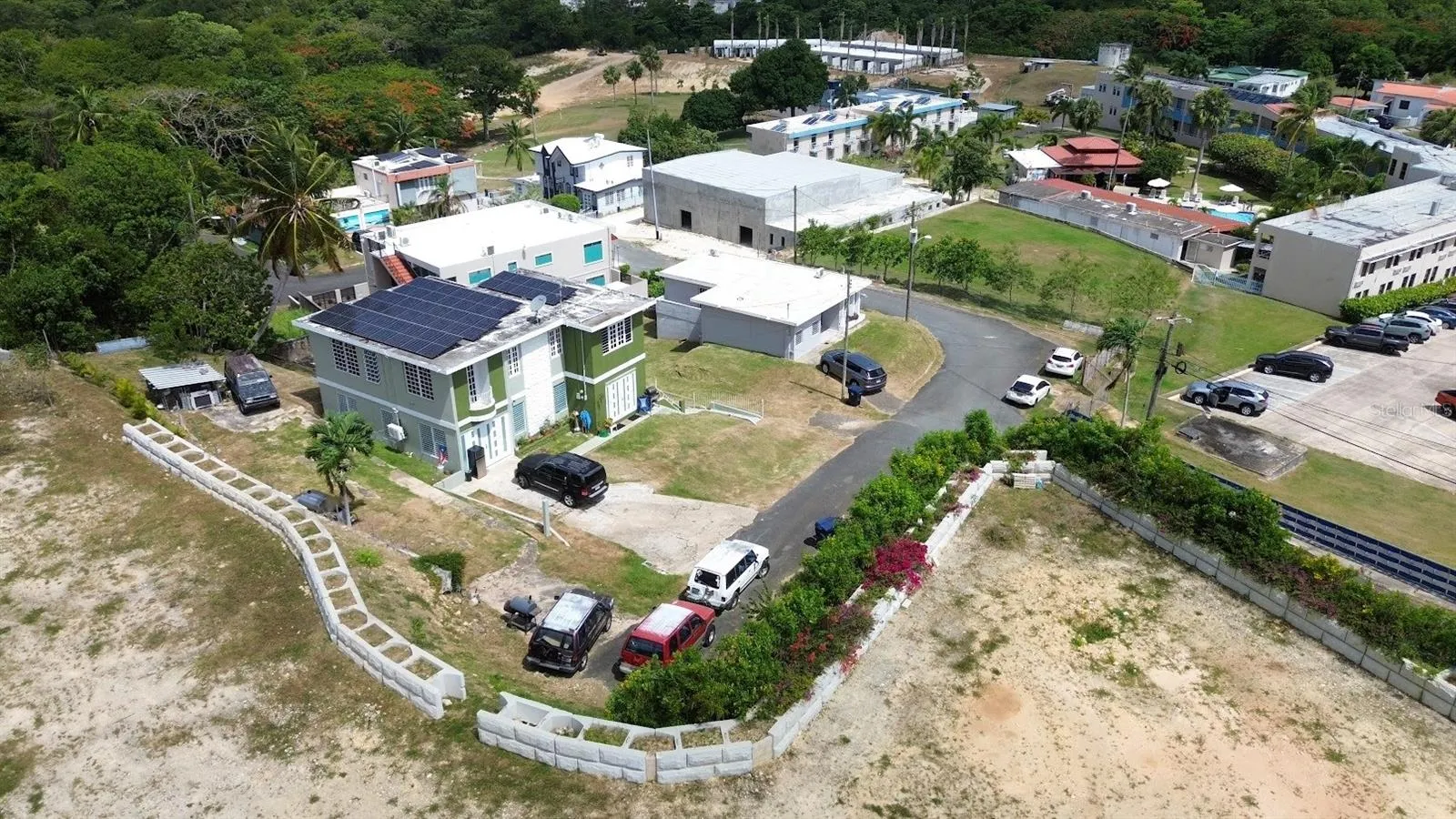 Aerial view showing the property's footprint, parking area, and surrounding neighborhood.