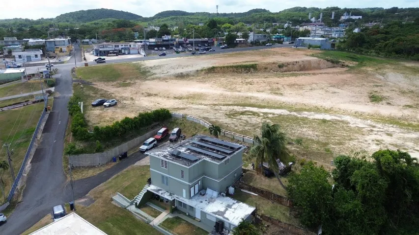 Aerial view showing the property's footprint, parking area, and surrounding neighborhood.