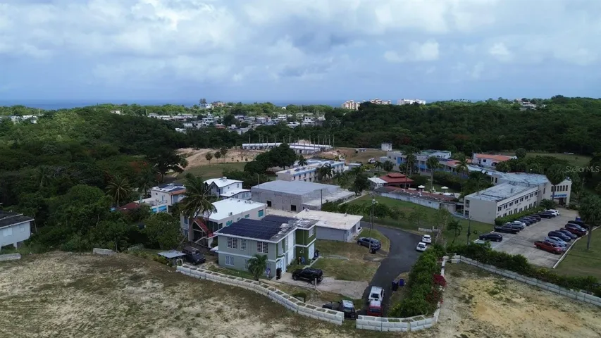 Aerial view showing the property's footprint, parking area, and surrounding neighborhood.