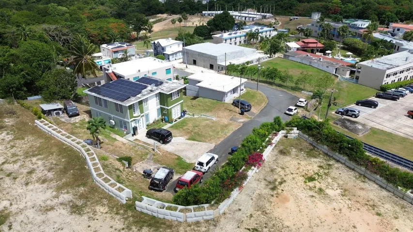 Aerial view showing the property's footprint, parking area, and surrounding neighborhood.