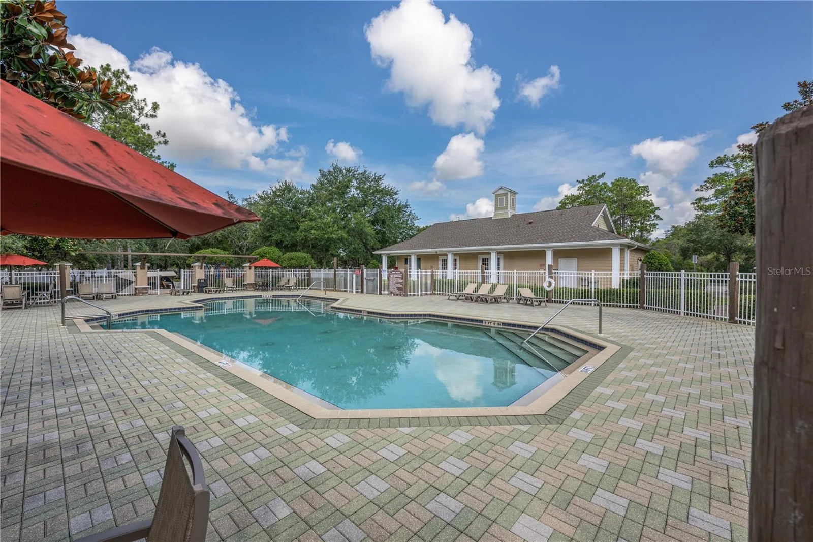 Relax at the community pool with a spacious sun deck, shaded seating, and convenient access to the clubhouse.