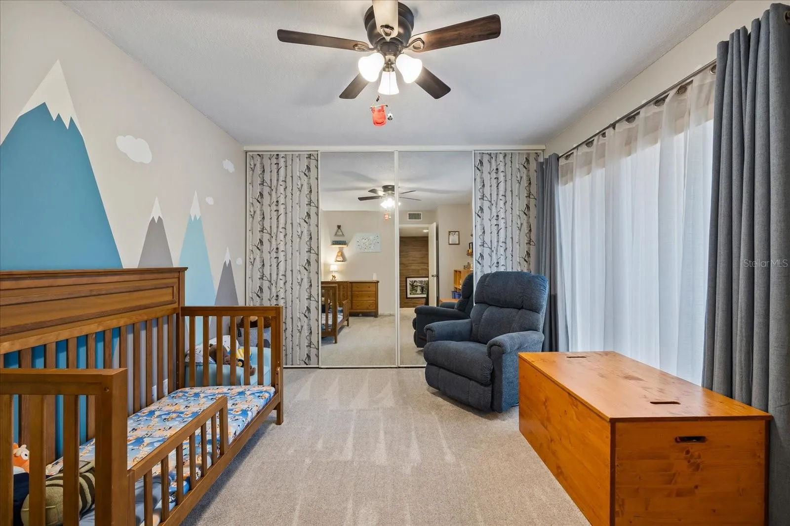 Guest bedroom upstairs offers varied use from office, hobby, or nursery, featuring wall-to-wall closet space and private balcony access.