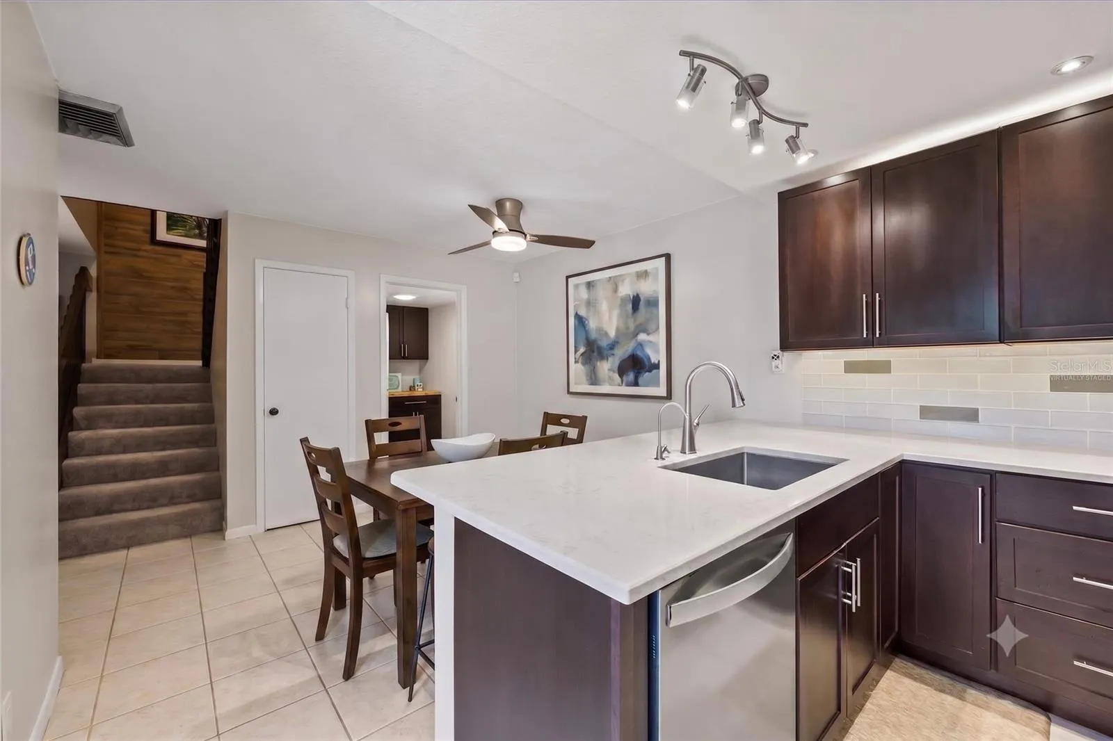 Hosting intimate dinner parties or meal prepping for the week will be a delight in this attractive yet functional kitchen space, virtually staged to show optimal use of the space in the dining area.