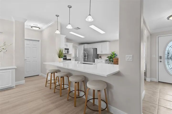 UPDATED QUARTZ COUNTER TOPS AND ADDED COUNTER HEIGHT SEATING
