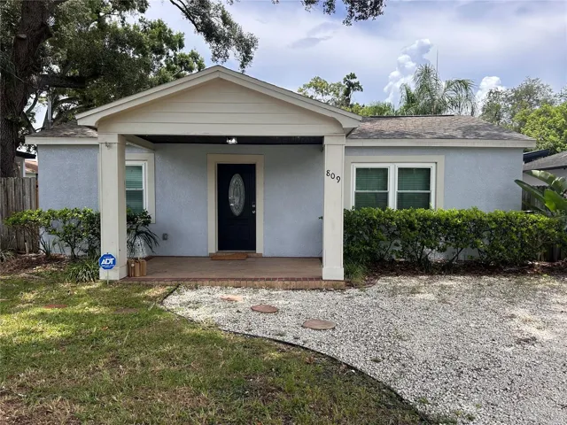 Front of house featuring professional landscaping and high curb appeal.