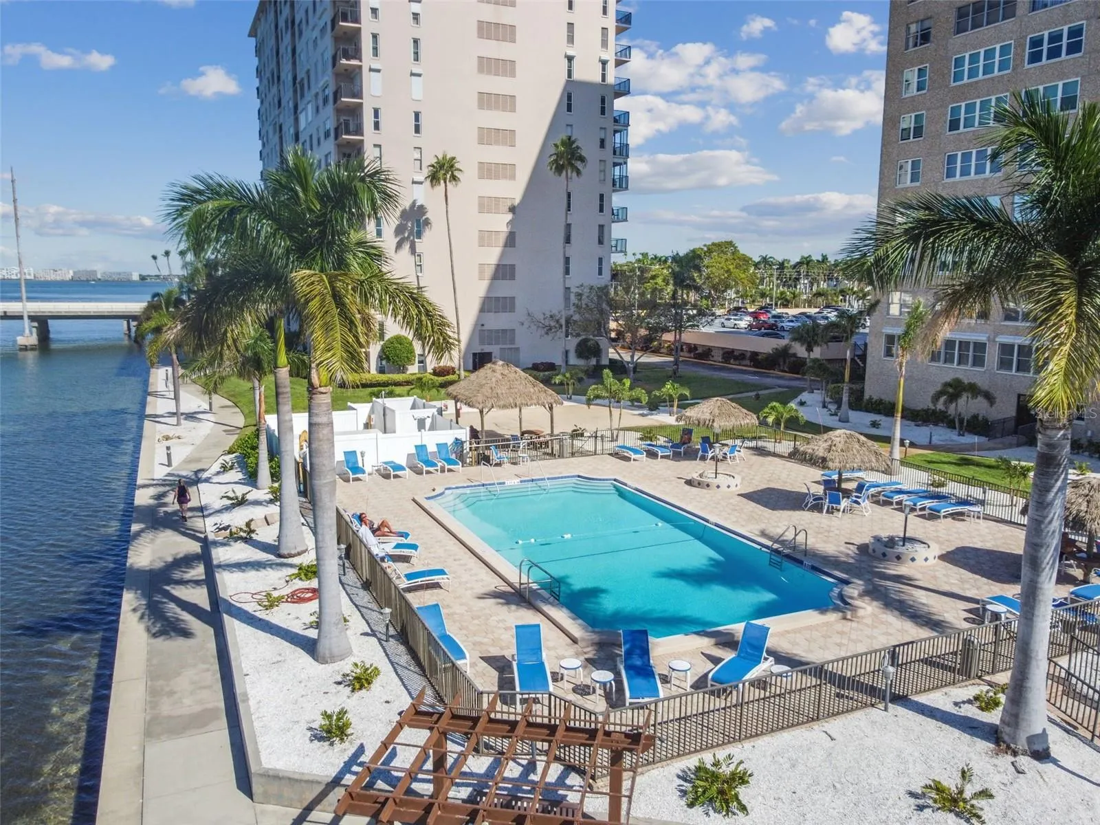 Paradise at the pool ~ directly on the water AND connected to your building! Grilling area, loungers, tiki cabanas, and all the palm trees and coastal living you have been dreaming of!