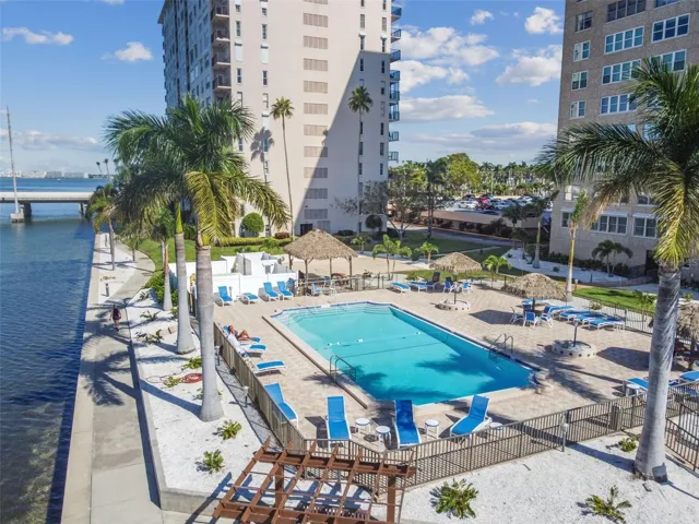 Paradise at the pool ~ directly on the water AND connected to your building! Grilling area, loungers, tiki cabanas, and all the palm trees and coastal living you have been dreaming of!