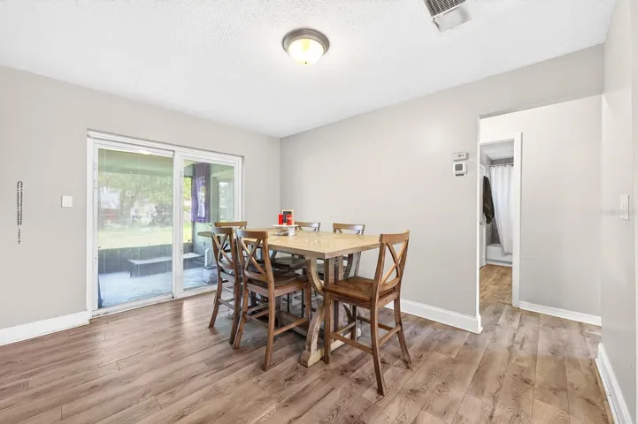 Dining area has sliding glass doors that open to the screened lanai.