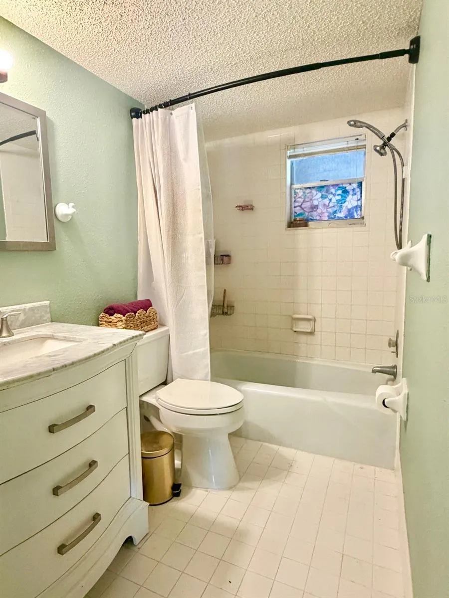 Bath with tub shower and updated vanity