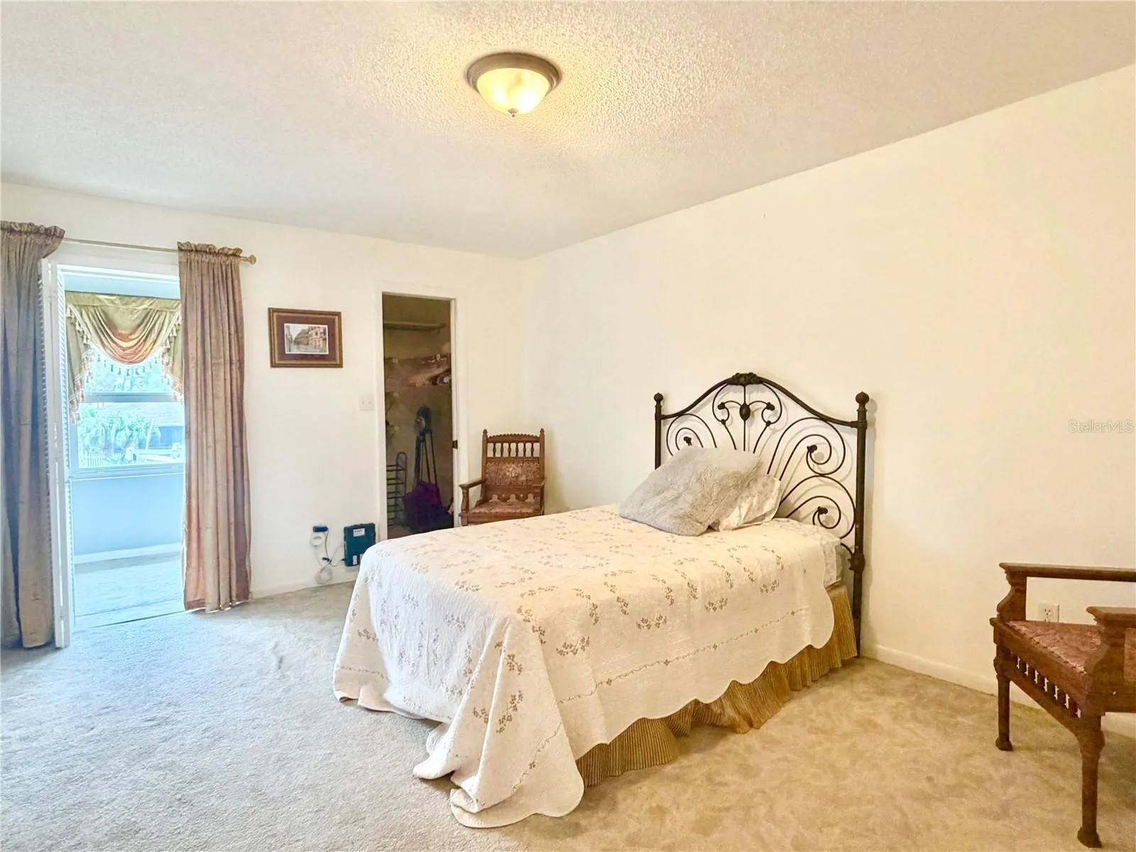 Bedroom with walk in closet and door to Florida room