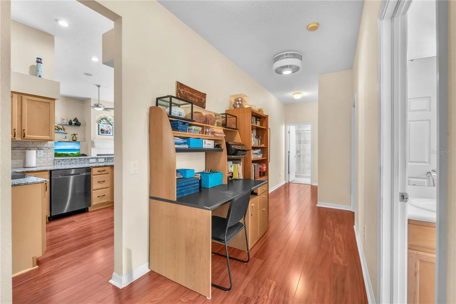 Three additional bedrooms are thoughtfully situated on the opposite side of the home, creating a private wing ideal for family and guests including a versatile flex space with endless possibilities as a cozy reading nook, homework station, additional sitting area or shared office as currently furnished.