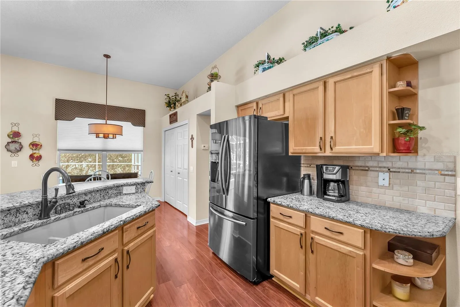 Black stainless steel appliances, granite counters, quartz granite composite sink with double basin, loads of work space and double closet door pantry to store all kitchen essentials.