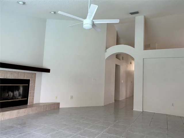 Family room has tile, fireplace, high ceilings