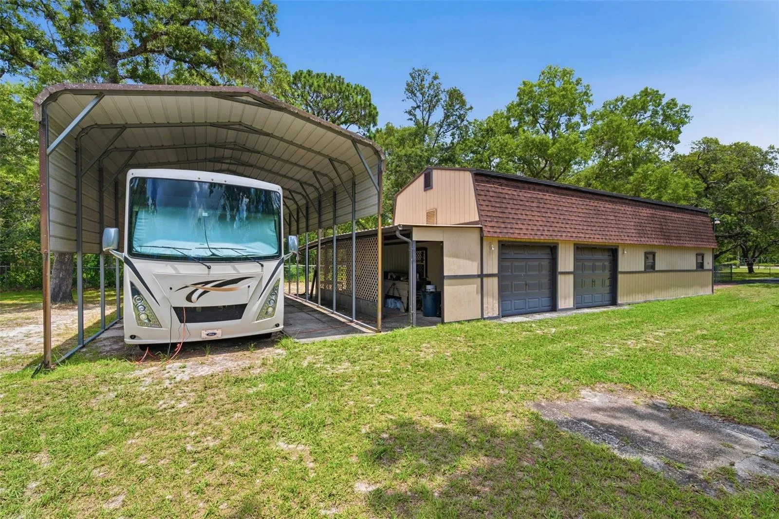 RV carport & side view of the barn/garage.