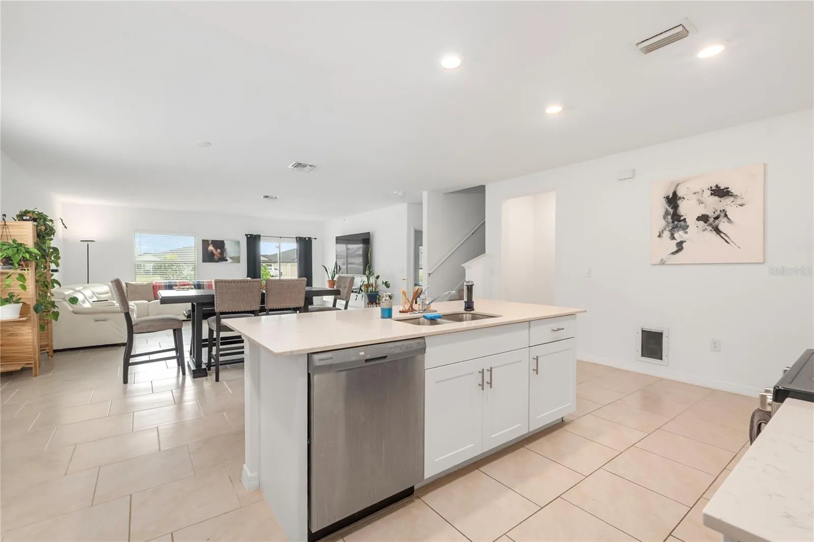 Gourmet kitchen with large center island, abundant cabinetry, and seamless flow into the living and dining areas.
