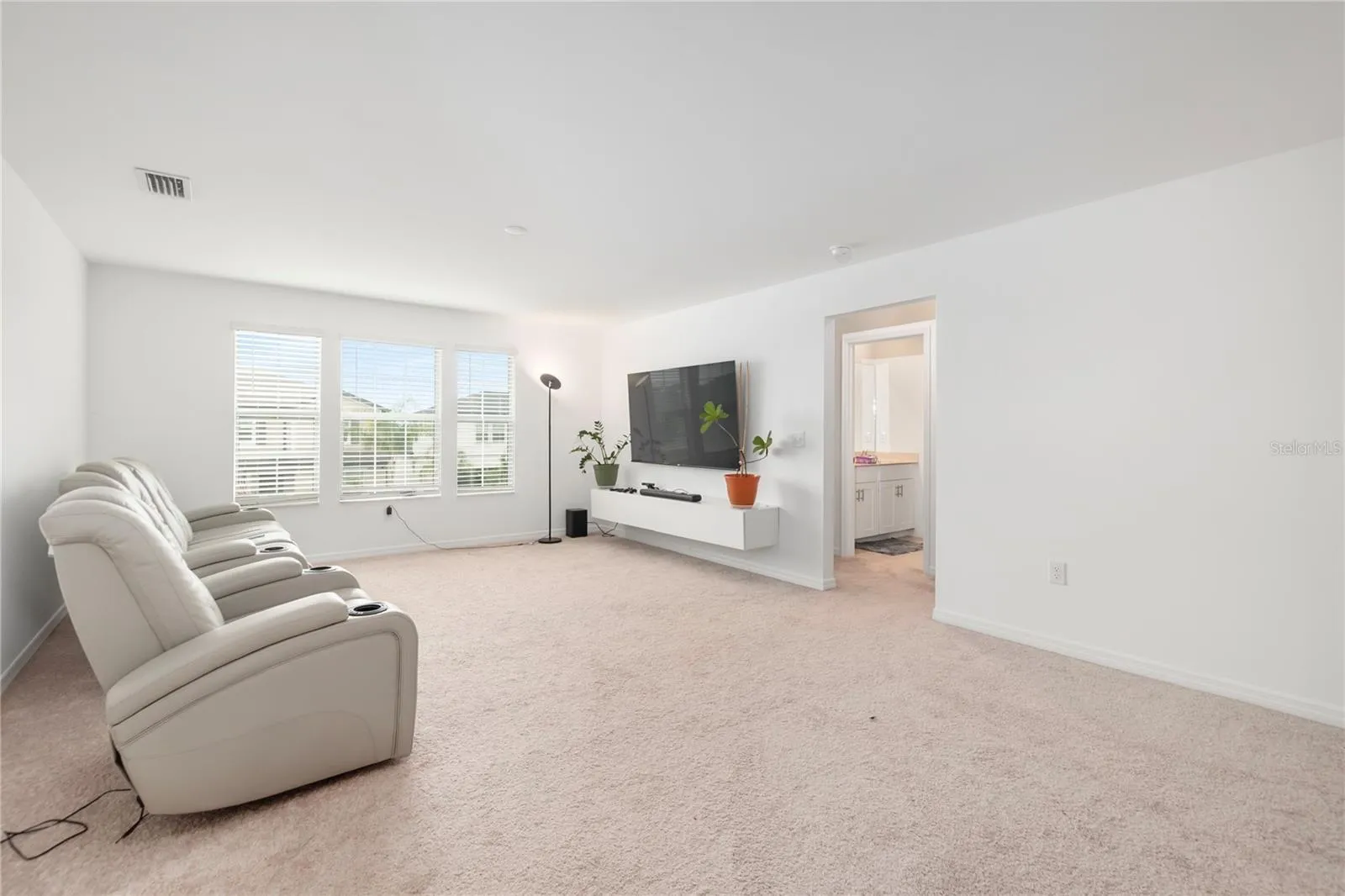 Expansive upstairs loft perfect for a media room, game room, fitness space, or second living area.