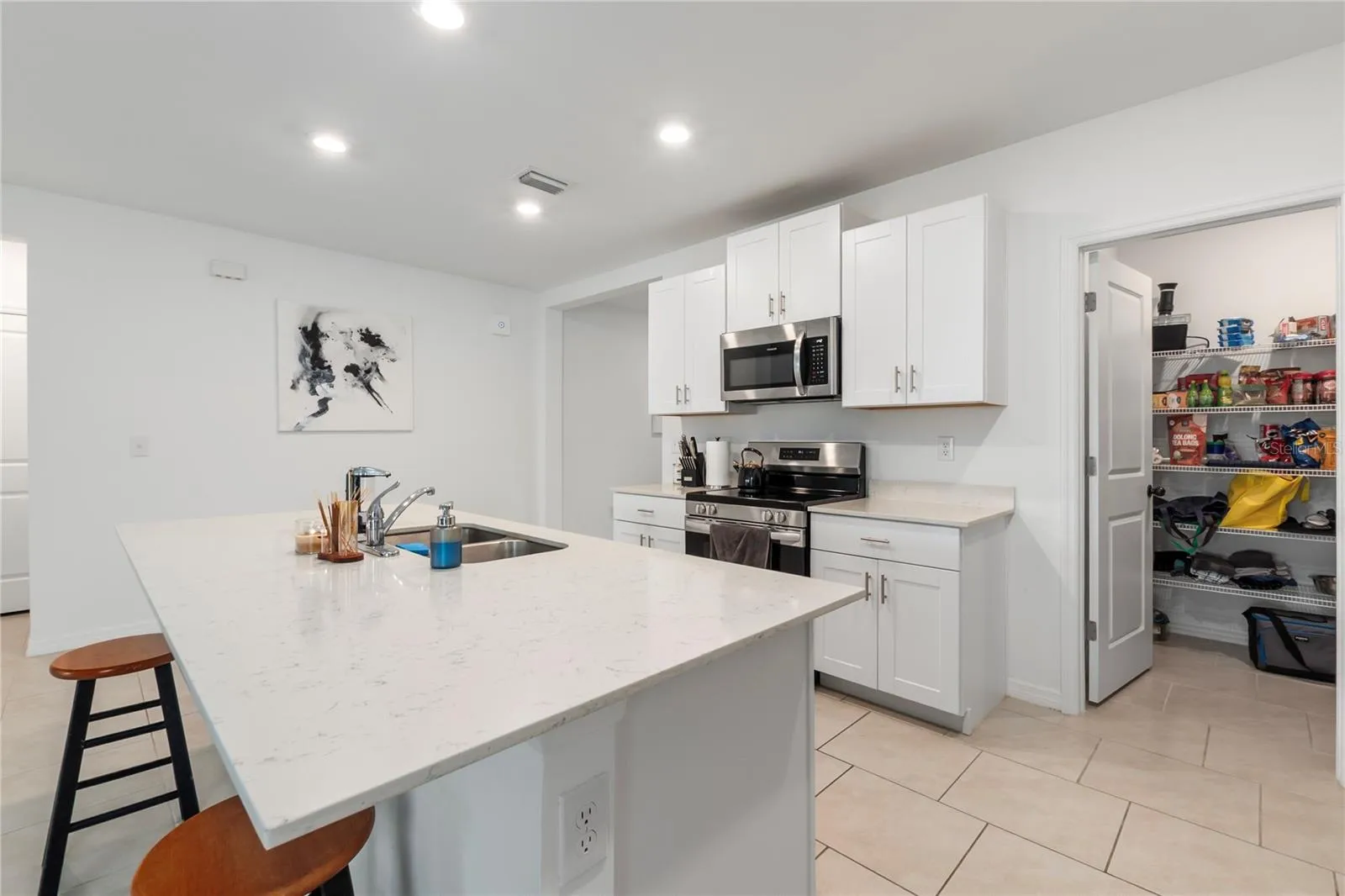 Gourmet kitchen with large center island, abundant cabinetry, and seamless flow into the living and dining areas.