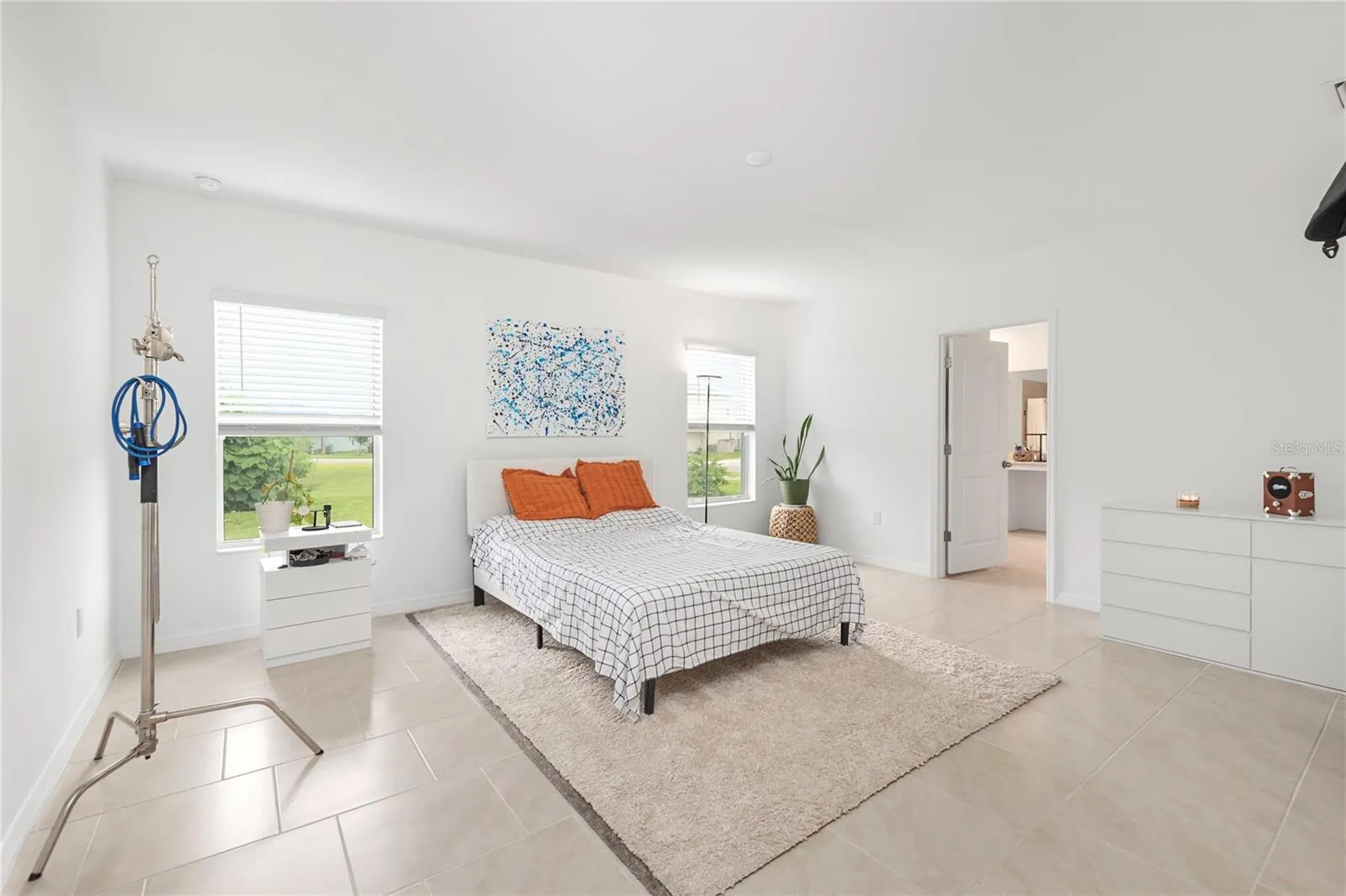 Spacious primary suite with oversized windows, natural light, and room for a king-sized bedroom