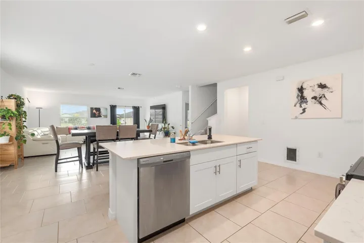 Gourmet kitchen with large center island, abundant cabinetry, and seamless flow into the living and dining areas.