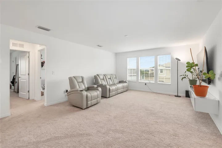 Expansive upstairs loft perfect for a media room, game room, fitness space, or second living area.