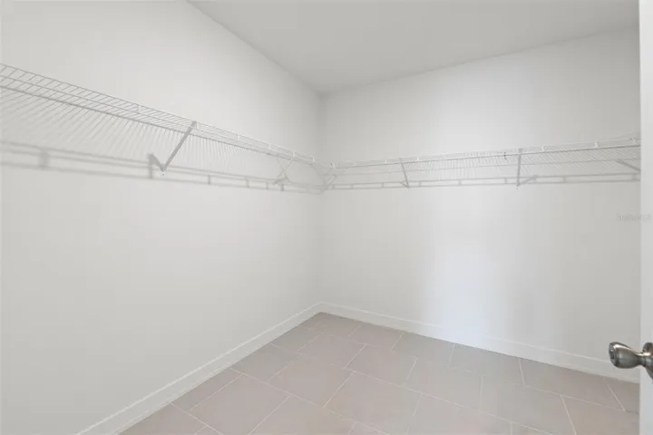 Oversized walk-in closet offering exceptional storage and organization in the primary suite.
