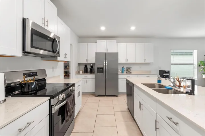 Gourmet kitchen with large center island, abundant cabinetry, and seamless flow into the living and dining areas.