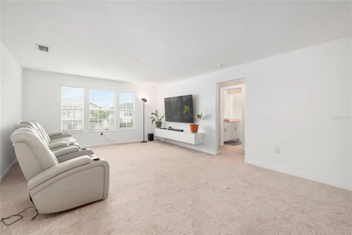 Expansive upstairs loft perfect for a media room, game room, fitness space, or second living area.