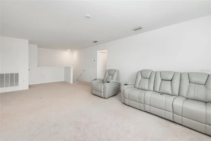 Expansive upstairs loft perfect for a media room, game room, fitness space, or second living area.