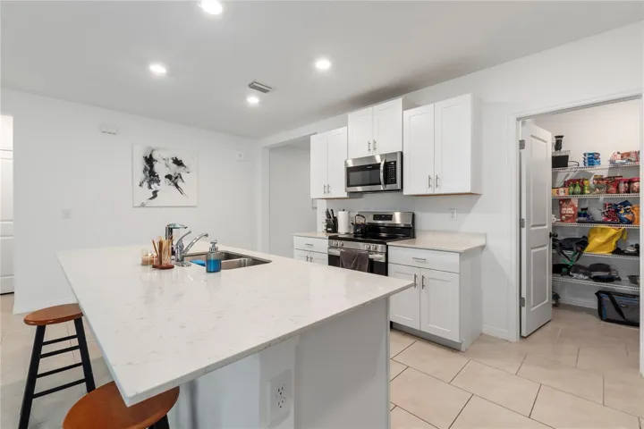 Gourmet kitchen with large center island, abundant cabinetry, and seamless flow into the living and dining areas.