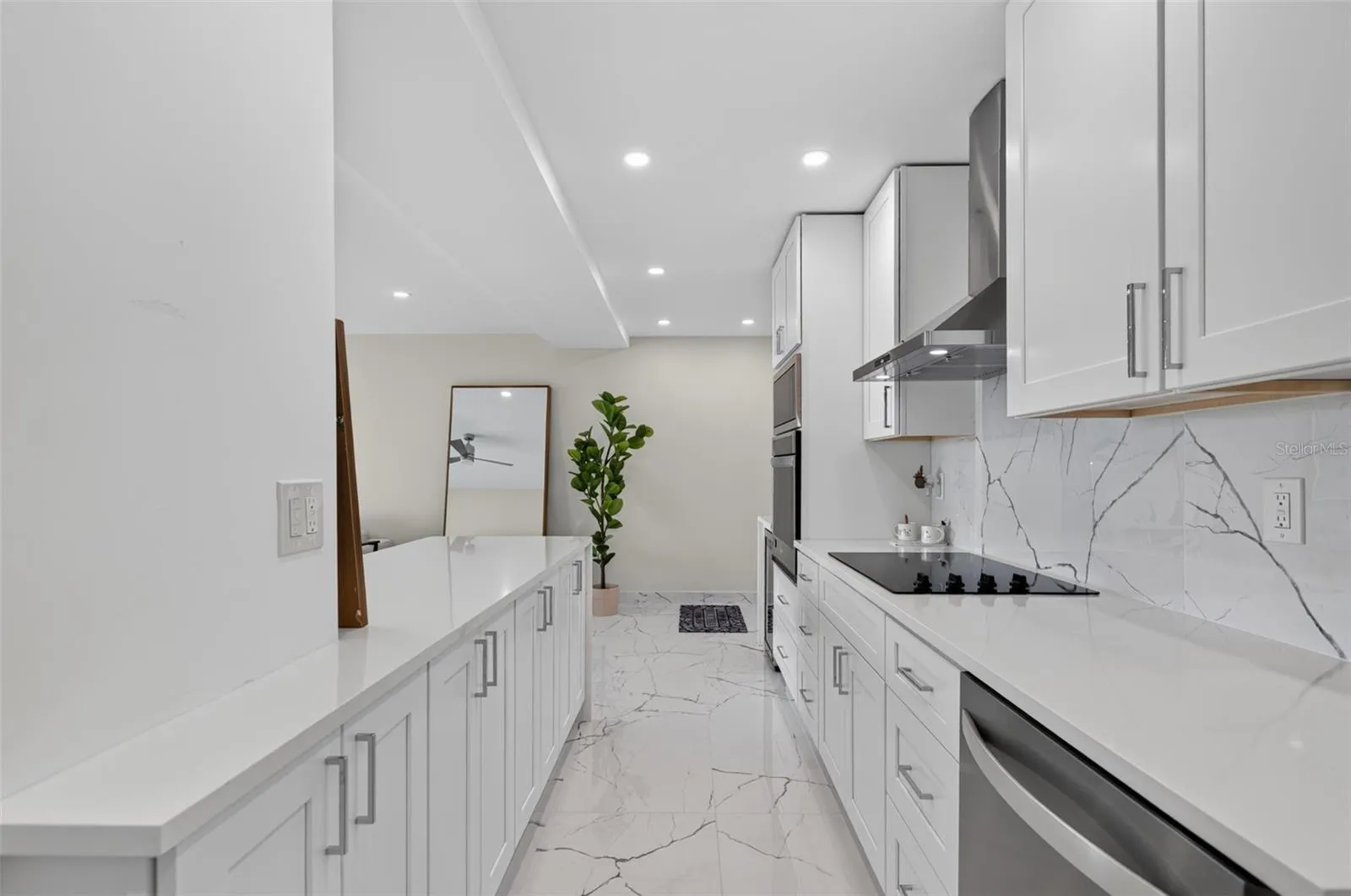As you enter your home you will see the modern updated kitchen with stainless steel appliances and solid surfact counters and backsplash