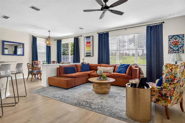 Living room fits large sectional with views of the backyard