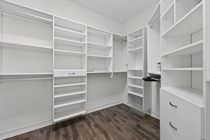 Primary suite custom walk-in closet.