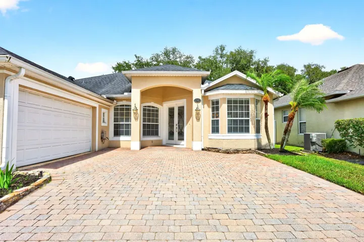 2-car sider facining garage, paver driveway.