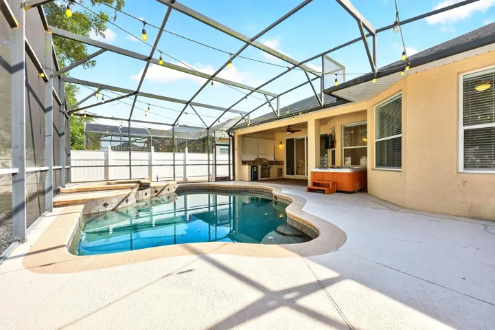 Covered lanai overlooks a private screened pool.