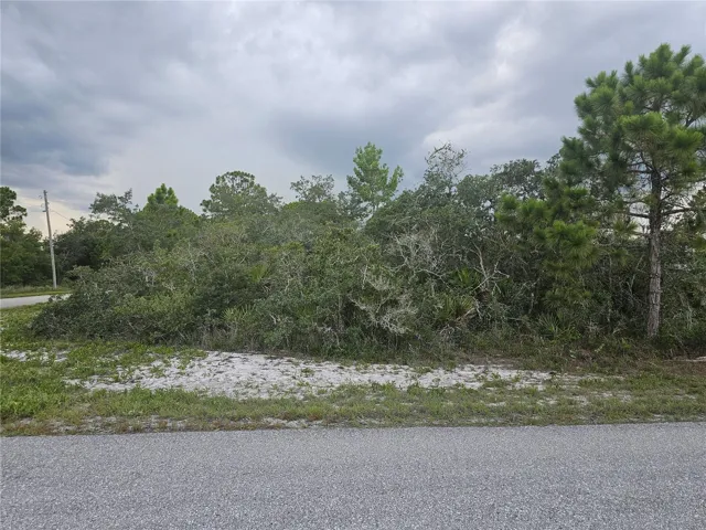 Check out this corner lot with entry on both sides on a paved road.